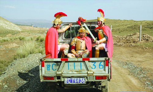 Villagers, dressed in armor, drive to a show. Photo: IC