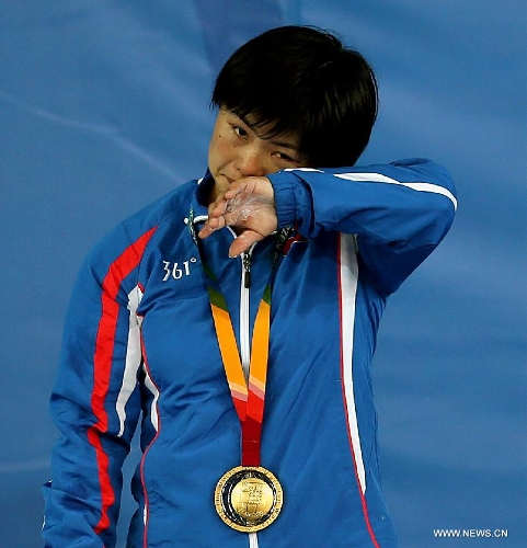 Gold medalist Pyon Yong Mi of the Democratic People's Republic of Korea (DPRK) cries during the awarding ceremony of women's 63kg weightlifting at the 27th Summer Universiade in Kazan, Russia, July 9, 2013. Pyon Yong Mi claimed the title with 233kg in total. (Xinhua/Li Ying) 