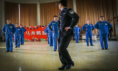 A police officer teaches tap dancing to drug addicts at Tiantanghe drug rehabilitation center on Monday in Daxing district, Beijing. The center is administered by Beijing security bureau. Some officers have been trained to be fitness instructors. Photo: CFP