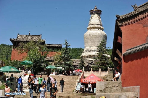 Tourists visit a temple on Mount Wutai, one of four sacred Buddhist mountains in China, in north China's Shanxi Province, June 26, 2013. Added to UNESCO's World Heritage List in 2009, Mount Wutai is home to about 50 Buddhist temples built between the 1st century AD and the early 20th century. (Xinhua/Zhan Yan)