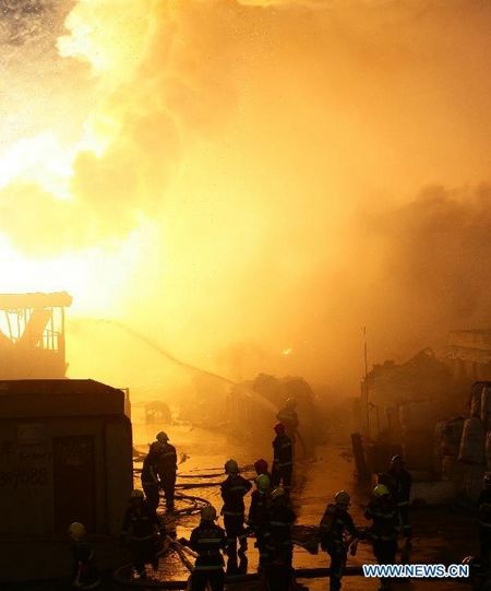 Firefighters hose down fire at a workshop in Zhenhai District of Ningbo, East China's Zhejiang Province, August 1, 2012. The fire broke out in a renewable resources plant in Ningbo at about 5 pm Wednesday, leave one person dead and 18 others injured. The investigation of the reason of the fire is underway. Photo: Xinhua