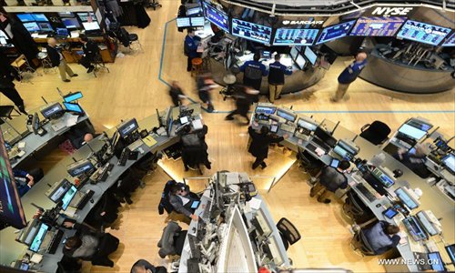 Traders work on the floor of the New York Stock Exchange, New York, the United States, on January 2, 2013.
