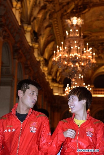 Chinese player Ding Ning (R) talks with her compatriot Zhang Jike during the official draw of the upcoming World Table Tennis Championships in Paris, France, May 11, 2013. The world championships will kick off on May 13 and the final event will be held on May 20. (Xinhua/Tao Xiyi) 
