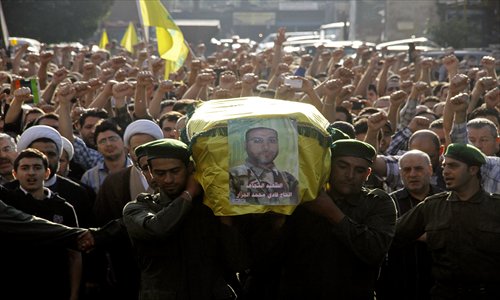 Members of Lebanon's Hezbollah carry the coffin of their comrade Fadi Mohammed al-Jazzar during his funeral in southern Beirut on Monday. Photo: <em>AFP</em>