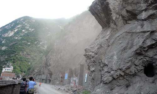 rocks falling from a hill in Luozehe Town, Yiliang County, southwest China's Yunnan Province, Sept. 7, 2012.