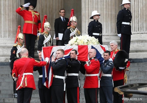 The coffin of British former prime minister Margaret Thatcher is carried out of St. Paul's Cathedral following the ceremonial funeral service in London, Britain, April 17, 2013. The funeral of Margaret Thatcher, the first female British prime minister, started 11 a.m. local time on Wednesday in London. (Xinhua/Yin Gang)