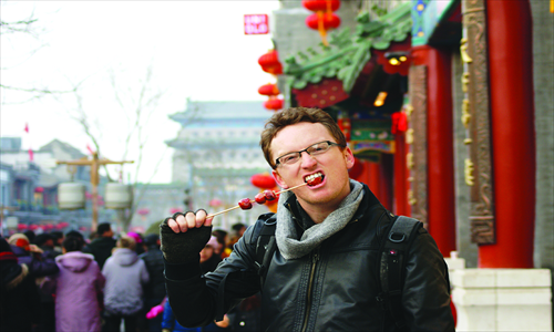3. Eating Beijing snack tanghulu (candied haws) in the heart of Qianmen 
