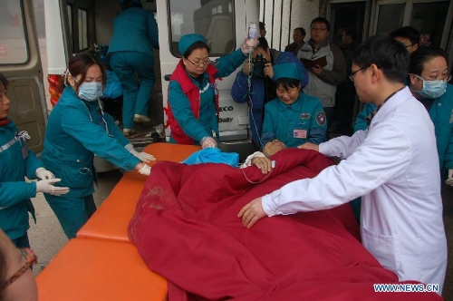 A victim of an accident in which an expressway bridge partially collapsed due to a truck explosion in Mianchi County, receives treatment at a hospital in Sanmenxia, central China's Henan Province, Feb. 1, 2013. The explosion, which occurred around 8:52 a.m. (0052 GMT) on Feb. 1, caused several vehicles to tumble from the bridge. At least four people died and eight others were injured, the city government of Sanmenxia said. Search and rescue efforts are under way. (Xinhua/Gao Yong) 