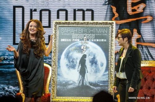 British singer Sarah Brightman poses with a poster of her China tour performance in Beijing, capital of China, Feb. 28, 2013. The British soprano will kick off her China tour Dreamchaser as she will perform in Beijing, Shanghai, Taipei, Guangzhou, Shenzhen and Nanning. (Xinhua/Zhang Yu) 