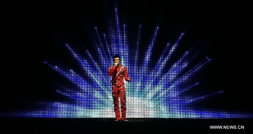 Chinese-American singer-songwriter Leehom Wang performs during Leehom Wang Music Man II-Open Fire at O2 Arena in London, Britain, April 15, 2013. (Xinhua/Wang Lili)  