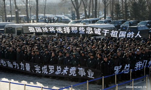 People attend a memorial service for Luo Yang, head of the production phase for China's new J-15 fighter jet, who died of a heart attack on November 25, in the Huilonggang Cemetery for Revolutionaries in Shenyang, capital of northeast China's Liaoning Province, November 29, 2012. Luo experienced a heart attack after observing aircraft carrier flight landing tests for China's first aircraft carrier, the Liaoning, on November25. He later died in hospital at the age of 51. He was also chairman and general manager of Shenyang Aircraft Corp. (SAC), a subsidiary of China's state-owned aircraft maker, Aviation Industry Corp. of China (AVIC). Photo: Xinhua