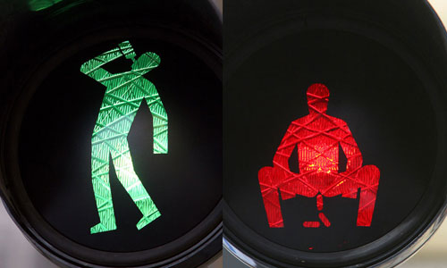 Altered traffic signs with red and green men appearing to lie down, drink and defecate appearin Prague in April 2012. The signs were deemed illegal and were removed by the authorities, Guerrilla art group Ztohoven claimed responsibility. Photo:ImagineChina