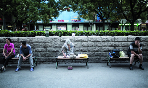 Outside the hospital, people wait their turn to make an appointment.
