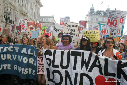 Women hold banners and shout slogans as they take part in a 