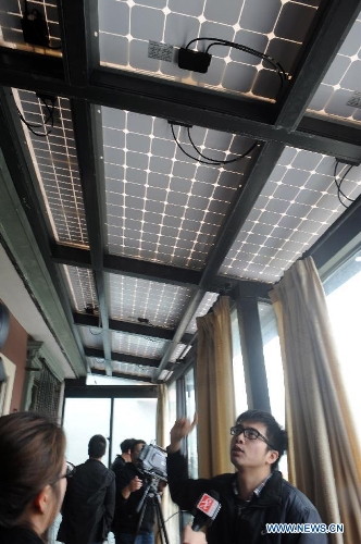 Photo taken on April 8, 2013 shows Mo Zhikai, owner of a homemade photovoltaic power station made on his own, introduces his power station at his house in Wumeng Village of Ningbo City, east China's Zhejiang Province. (Xinhua/Gong Guorong) 