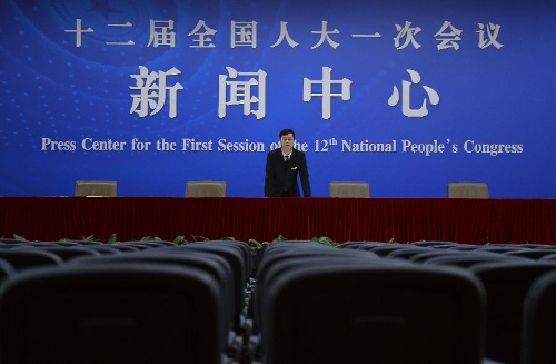   A staff member examines a press room of the press center for the 2013 sessions of the National People's Congress (NPC) and the Chinese People's Political Consultative Conference (CPPCC) in Beijing, capital of China, Feb. 26, 2013. The upcoming annual sessions of the NPC, China's top legislature, and the CPPCC, the country's top political advisory body, launched a press center Tuesday in the Media Center Hotel in downtown Beijing. (Xinhua/Jin Liangkuai) 