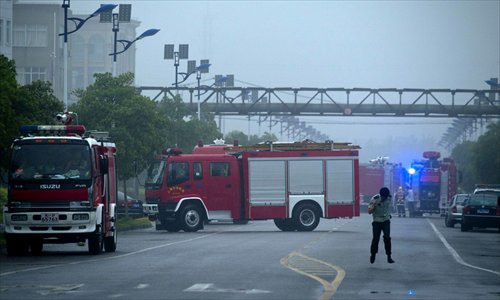 Fire engines surround a chemical company in Jinshan district Monday afternoon after an explosion there left six workers injured. Sixty-eight fire engines were dispatched to the scene and had the blaze under control within an hour. Four firefighters were also injured. The cause of the explosion remains under investigation. Photo: Yang Hui/GT