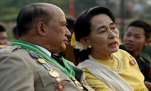Opposition leader Aung San Suu Kyi (right) speaks with Major General Zaw Win, deputy minister for border affairs, during a ceremony marking Myanmar's 68th Armed Forces Day at a parade ground in Nay Pyi Taw on Wednesday. Suu Kyi attended Myanmar's Armed Forces Day for the first time. Photo: AFP