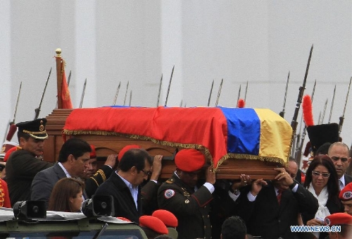 The body of late Venezuelan President Hugo Chavez is carried from the Military Academy to the Mountain Barracks, in the city of Caracas, capital of Venezuela, on March 15, 2013. Venezuelans honored late President Hugo Chavez, before his remains were transfered to the Mountain Barracks, where he will rest inside a glass case. Venezuelan President died on March 5, after struggling with cancer for two years. (Xinhua/AVN) 
