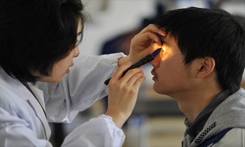 Students undergo stringent vision examinations. Photo: CFP