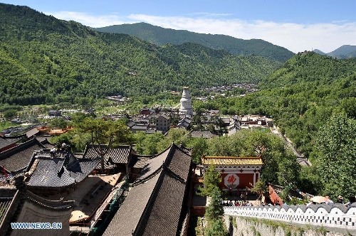Photo taken on June 26, 2013 shows the temple-dotted Taihuai Town, center of Mount Wutai's scenic area, in north China's Shanxi Province. Mount Wutai is one of four sacred Buddhist mountains in China. Added to UNESCO's World Heritage List in 2009, Mount Wutai is home to about 50 Buddhist temples built between the 1st century AD and the early 20th century. (Xinhua/Zhan Yan)