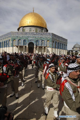 Palestinians take part in a ceremony commemorating the birth of Prophet Mohammed, known in Arabic as 