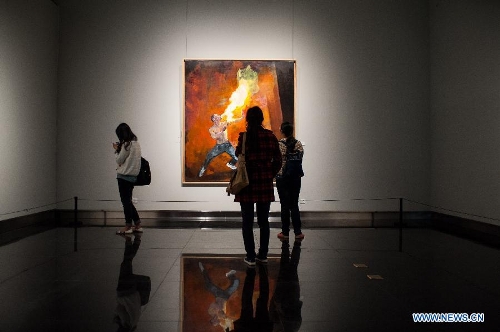 Visitors look at a painting by Han Xin during the 