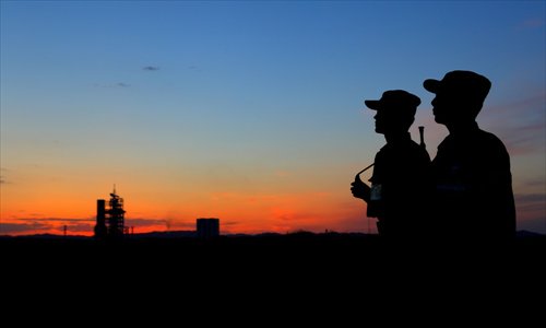 Soldiers stand guard near the launch pad where a rocket carrying the Shenzhou-9 spacecraft is prepared for liftoff at the Jiuquan Satellite Launch Center in Gansu Province on Tuesday evening. Photo: IC