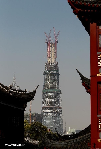 Photo taken on April 11, 2013 shows the Shanghai Tower under construction in east China's Shanghai Municipality. The height of the Shanghai Tower, which is still under construction, reached 501.3 meters Thursday, surpassing the neighbouring Jinmao Tower and the World Financial Center. The designed height of the Shanghai Tower will be 632 meters, the tallest skyscraper in China. (Xinhua/Pei Xin) 
