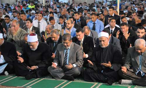 This photo provided by the Egyptian Presidency shows Egyptian president Mohamed Morsi (3rd, L) prays at a mosque in his hometown of Zagazig, Egypt, July 20, 2012. In Egypt, Ramadan began on Friday. 