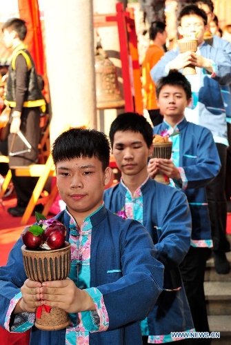Students from Taipei Kai-Ping Culinary School participate in a spring sacrificing ceremony at the Confucius Temple in Taipei, southeast China's Taiwan, March 10, 2013. The annual ancient-style ceremony was held here on Sunday to encourage students to set clear goals and study hard in the beginning of a year. (Xinhua/Wu Ching-teng) 