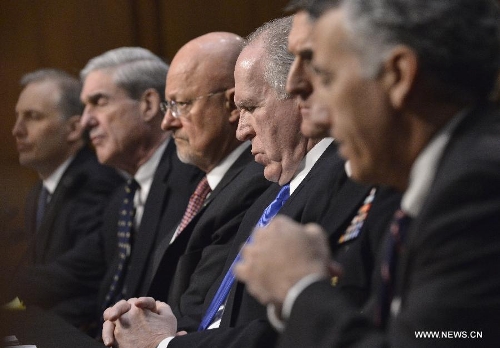 (L to R) National Counterterrorism Center Director Matthew Olsen, FBI Director Robert Mueller, Director of National Intelligence James Clapper, CIA Director John Brennan, Defense Intelligence Agency Director Michael Flynn, and Assistant Secretary of State for Intelligence and Research Philip Goldberg, testify before the Senate Select Intelligence Committee during a hearing on 