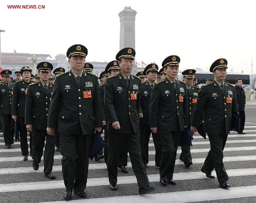   Deputies to the 12th National People's Congress (NPC) from the People's Liberation Army (PLA) walk to the Great Hall of the People in Beijing, capital of China, March 14, 2013. The fourth plenary meeting of the first session of the 12th NPC is to be held in Beijing on Thursday, at which Chairman, vice-chairpersons, secretary-general and members of the 12th NPC Standing Committee, president and vice-president of the state, and chairman of the Central Military Commission of the People's Republic of China will be elected. (Xinhua/Wang Peng) 