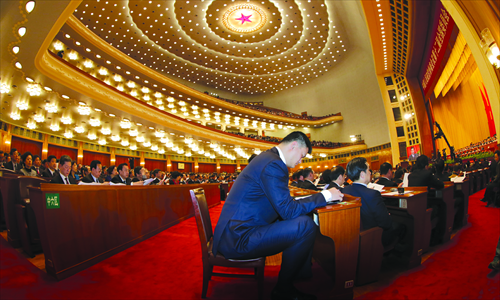 Basketball great and member of the CPPCC National Committee Yao Ming listens to speakers in the Great Hall of the People on Sunday. Photo: CFP