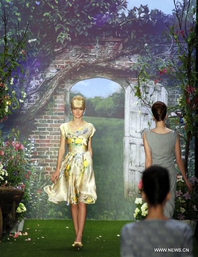 Models present creations by Austrian designer Lena Hoschek at the Spring/Summer 2014 Shows of the Mercedes-Benz Fashion Week, in Berlin, on July 2, 2013. (Xinhua/Pan Xu) 