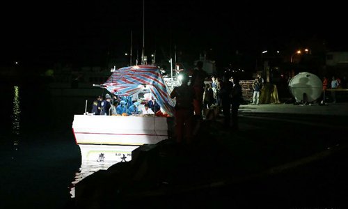 Forensic personnel check the body of a Taiwanese fisherman on fishing vessel 