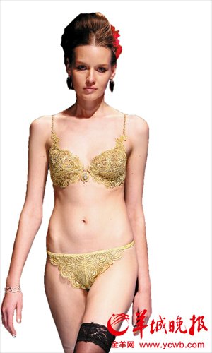 A model is dressed in a set of underwear made of pure gold during China Fashion Week in Beijing on October 24, 2011. The price was more than 4 million yuan ($649,522). Photo: Yangcheng Evening News