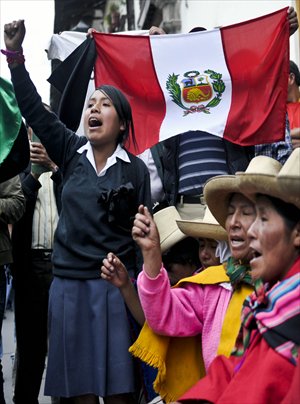 People shout slogans during a protest against the Conga mining project in Cajamarca, Peru on Monday. Protesters say the mining project will pollute the area's lakes and rivers and contaminate water supplies, while some say the project will benefit the local economy. Photo: AFP