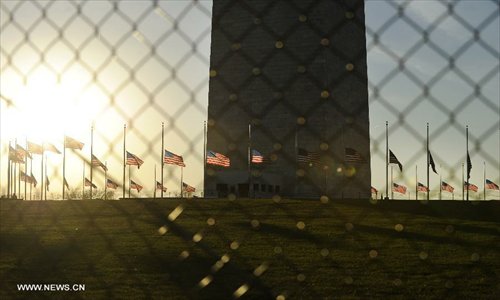 US flags fly at half staff at the base of the Washington Monument to honor the victims of the Connecticut shooting incident in Washington D.C., capital of the United States, Dec. 14, 2012. U.S. President Barack Obama on Friday ordered US flags to be flown at half-staff at the White House and all public buildings and grounds, as a mark of respect for the victims of a deadly shooting spree at Sandy Hook Elementary School in Newtown, Connecticut, which took place earlier in the day. Photo: Xinhua