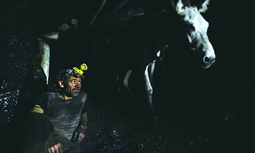 An Afghan miner rests inside a coal mine in Samangan province, north of Kabul on Tuesday. Afghanistan is believed to have mineral reserves worth as much as $3 trillion, which could theoretically generate billions of dollars in tax revenue for the troubled country. Photo: AFP