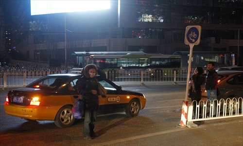 A female passenger is turned down by a taxi driver at Dongzhimen last December. Photo: CFP