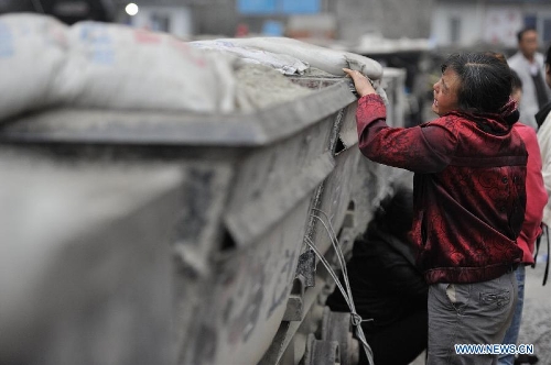 A family member of a miner cries at the site of the accident in Shuicheng County, southwest China's Guizhou Province, March 13, 2013. Twenty-one miners were killed and four others were missing in a coal and gas outburst Tuesday evening at Machang Coal Mine which belongs to Gemudi Company of Guizhou Water & Mining Group. Eighty-three miners were working underground when the accident took place, and 58 of them managed to get to the ground safely. (Xinhua/Ou Dongqu) 