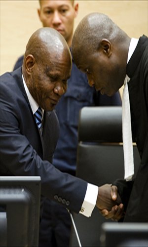 Congolese ex-militia boss Mathieu Ngudjolo Chui (left) shakes hands with one of his lawyers before the International Criminal Court acquitted him of war crimes on Tuesday. Prosecutors failed to prove his commanding role in the murder of 200 villagers in a 2003 attack in the Democratic Republic of Congo. Photo: AFP