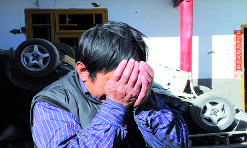 Ma Jiankang is overcome with emotion as he surveys his destroyed home on February 1. Photo: Li Qian/GT