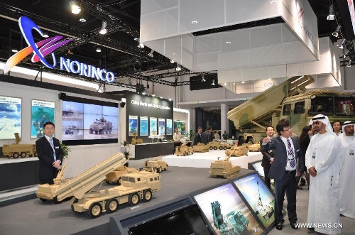 Abu Dhabi's Crown Prince Sheikh Mohammed bin Zayed Al Nahyan (1st R) visits the booth of China North Industries Corp. during the Defense Exhibition and Conference (IDEX) 2013 in Abu Dhabi, the United Arab Emirates, Feb. 18, 2013. (Xinhua) 