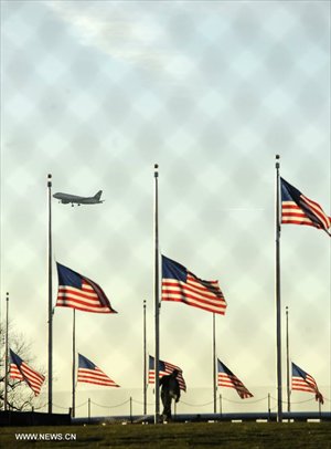 A National Park Service employee lowers a flag at the base of the Washington Monument to half staff to honor the victims of the Connecticut shooting incident in Washington D.C., capital of the United States, Dec. 14, 2012. US President Barack Obama on Friday ordered US flags to be flown at half-staff at the White House and all public buildings and grounds, as a mark of respect for the victims of a deadly shooting spree at Sandy Hook Elementary School in Newtown, Connecticut, which took place earlier in the day. Photo: Xinhua