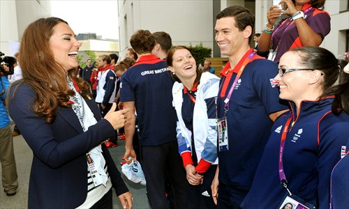 Catherine, Duchess of Cambridge, laughs as she talks with Britain cyclist Victoria Pendleton (right) during a visit to Team GB accommodation flats in the Athletes Village at the Olympic Park in Stratford, east London, on July 31. Photos: AFP