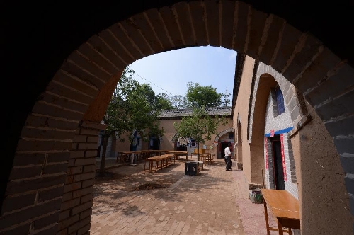 Photo taken on May 18, 2013 shows a renovated sunken courtyard in Qucun Village of Zhangbian Township in Shaanxian County, central China's Henan Province. The sunken courtyard, a kind of traditional residential construction in west Henan, has a high value in the study of local histroy, architecture, geology and sociology. The Qucun Village has 115 sunken courtyards, most of which are under protective reconstruction. (Xinhua/Zhao Peng)