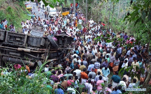 Local residents gather at the site of a bus accident at Idukki district of India's southern state Kerala, March 25, 2013. A school bus carrying students from Sarabhai Institute of Science and Technology fell into a deep ditch on Monday. (Xinhua/Stringer) 