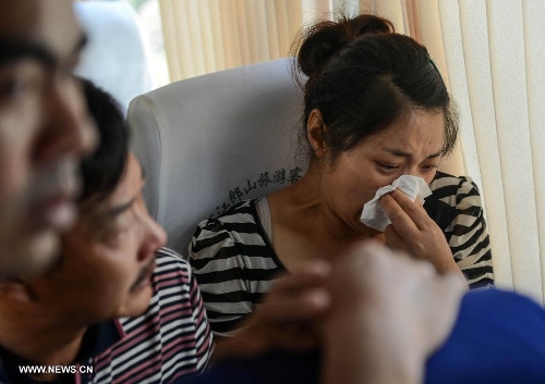 The relatives of an air crash victim sit on a bus from east China's Jiangshan to Shanghai to catch a plane for the United States, in Jiangshan City, east China's Zhejiang Province, July 8, 2013. Two Chinese passengers Wang Linjia and Ye Mengyuan were killed in a crash landing of an Asiana Airlines Boeing 777 at San Francisco airport on Saturday morning. Their family members headed for the United States on Monday. (Xinhua/Han Chuanhao) 